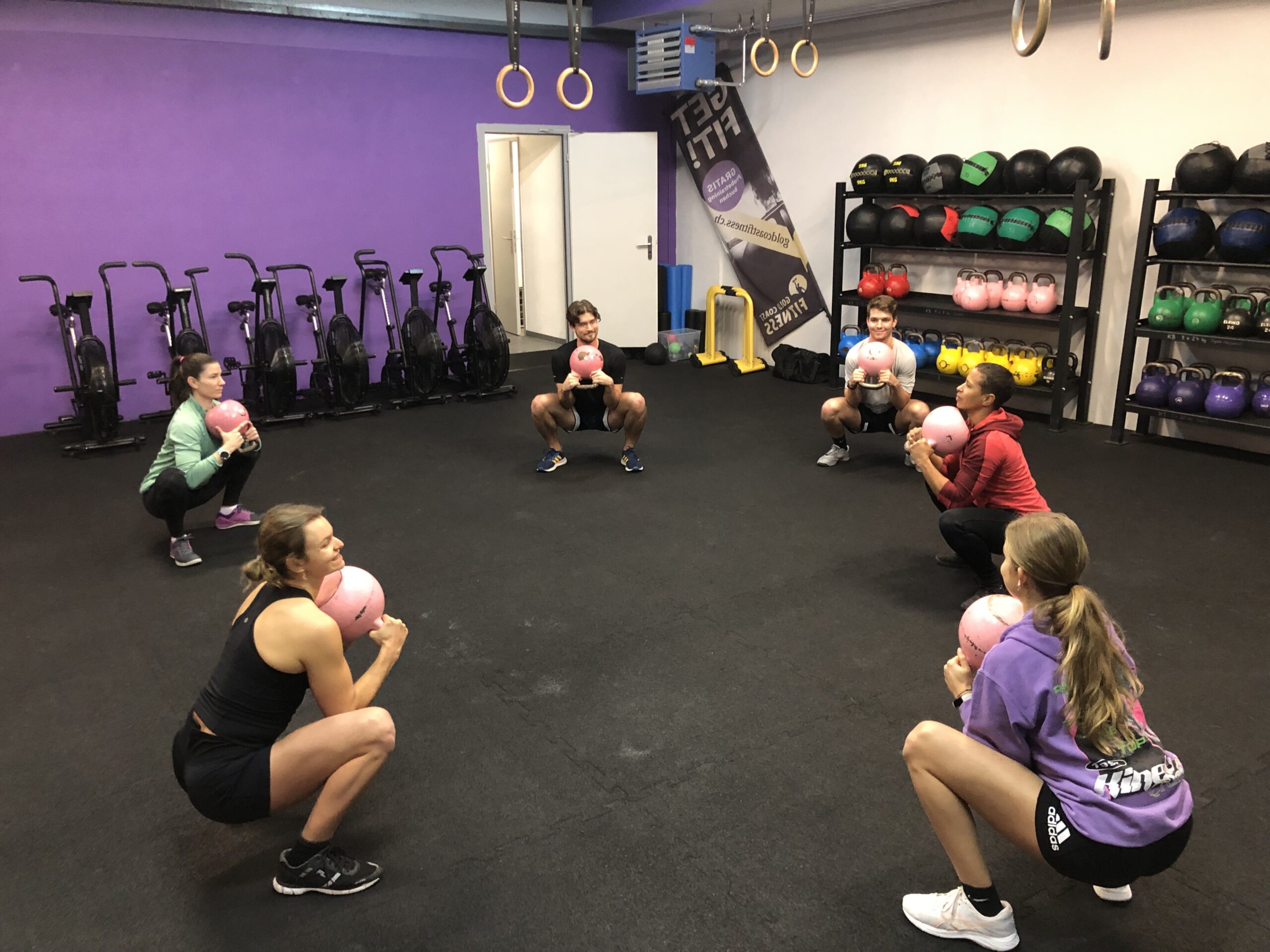 Cross training class doing goblet squats for warm-up